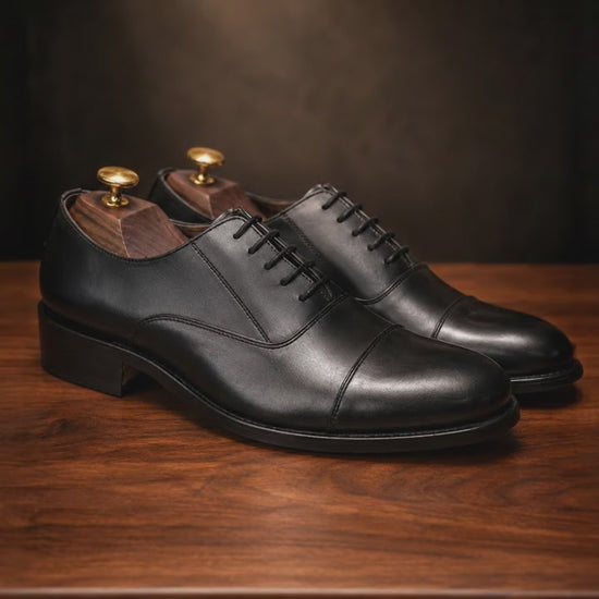 premium leather oxford shoes Standing on a walnut wooden table, Soft focus. spot light. realistic, 4k quality