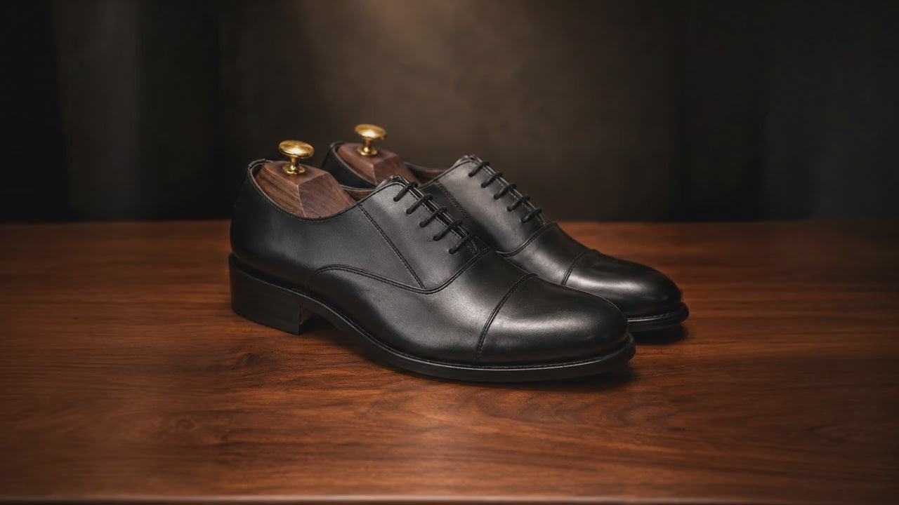 premium leather oxford shoes Standing on a walnut wooden table, Soft focus. spot light. realistic, 4k quality